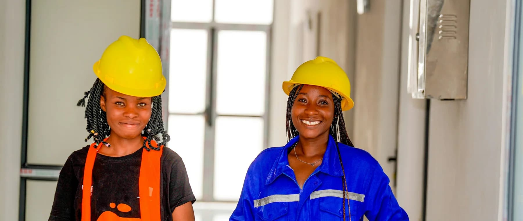 Workers in hard hats on site at a solar plant under construction