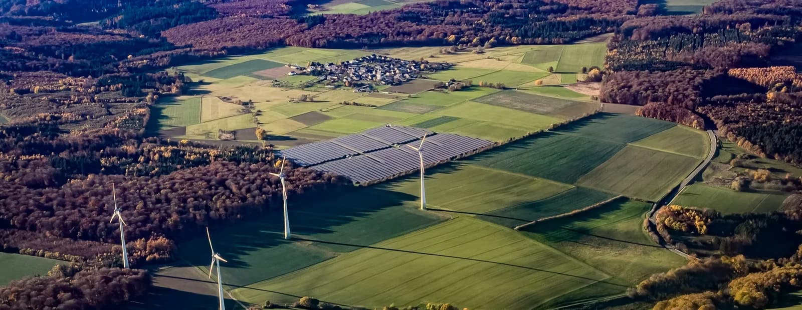 Wind turbines and solar panels in a rural landscape